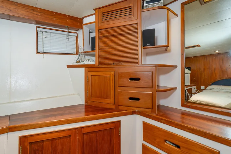 Slide: The Image of 1973 American Marine Alaskan 53 yacht interior with wooden cabinetry and mirror. - 34