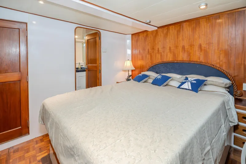 Slide: The Image of Cozy bedroom in 1973 American Marine Alaskan 53 yacht with wooden accents and nautical decor. - 35