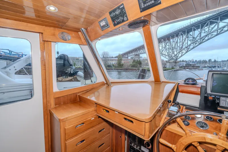 Slide: The Image of 1973 American Marine Alaskan 53 yacht interior with wooden helm and bridge view. - 4