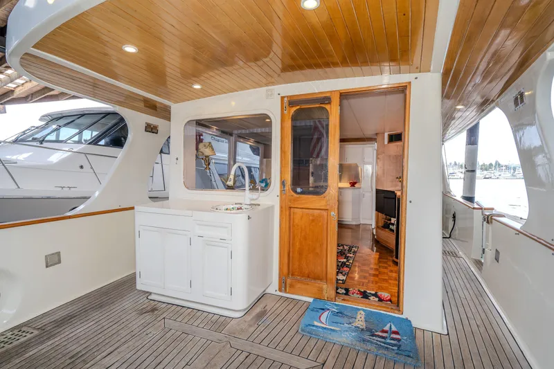 Slide: The Image of 1973 American Marine Alaskan 53 yacht interior with wooden deck and cozy cabin entrance. - 40