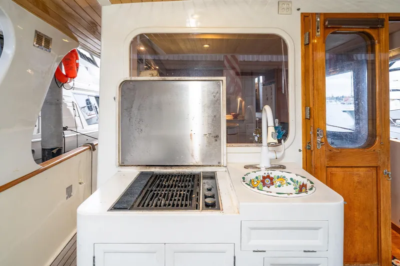Slide: The Image of Outdoor kitchen on 1973 American Marine Alaskan 53 yacht with grill and decorative sink. - 41