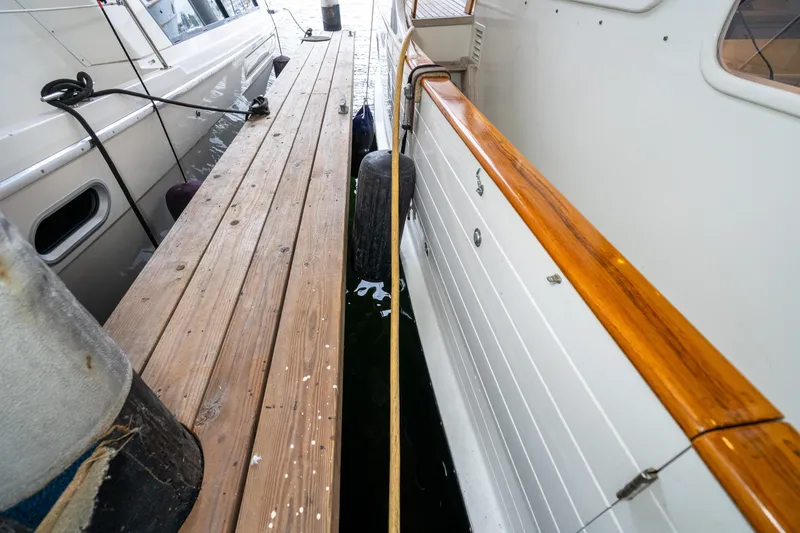 Slide: The Image of 1973 American Marine Alaskan 53 yacht docked beside wooden pier. - 45