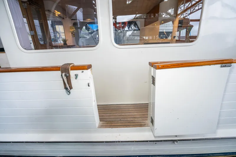 Slide: The Image of 1973 American Marine Alaskan 53 yacht with open deck door and wooden accents. - 47