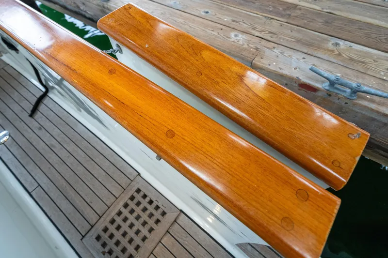 Slide: The Image of Polished wooden railings on a 1973 American Marine Alaskan 53 yacht deck. - 48