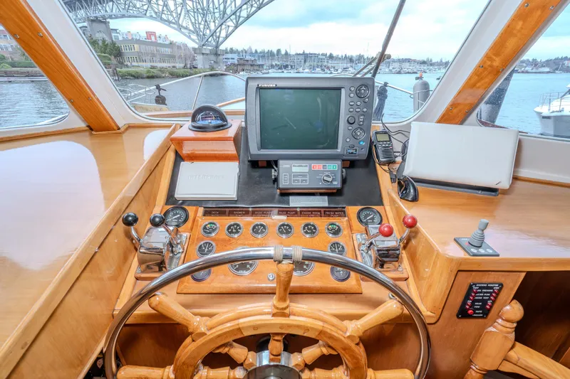 Slide: The Image of Helm of 1973 American Marine Alaskan 53 yacht with navigation equipment and wooden steering wheel. - 5