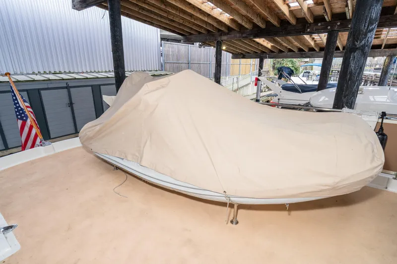 Slide: The Image of Covered boat on deck, American Marine Alaskan 53, 1973 model, under wooden shelter. - 57