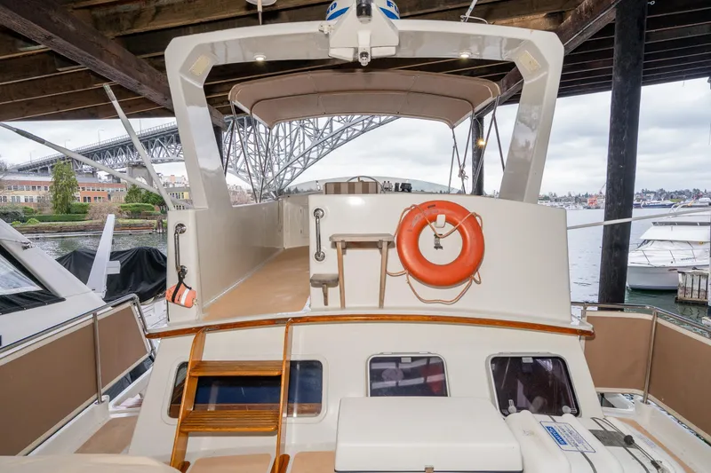 Slide: The Image of 1973 American Marine Alaskan 53 yacht docked under a bridge, featuring a life preserver. - 60