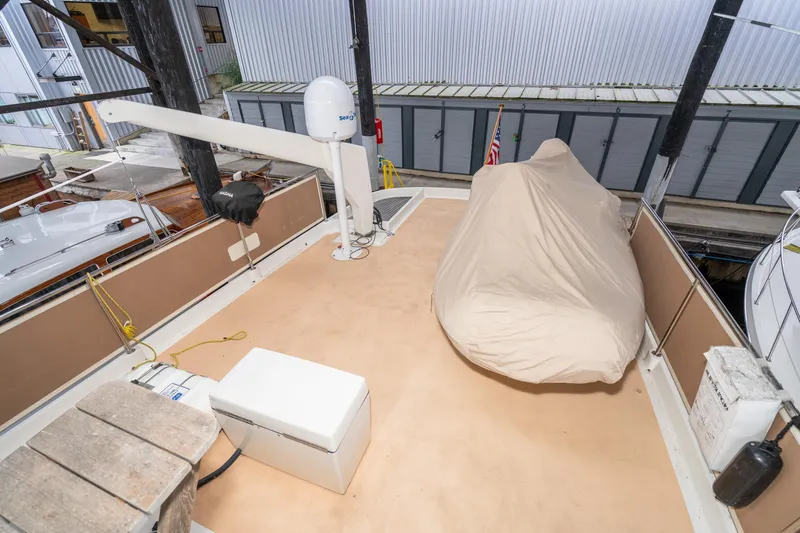 Slide: The Image of Deck of 1973 American Marine Alaskan 53 yacht with covered equipment and crane. - 61