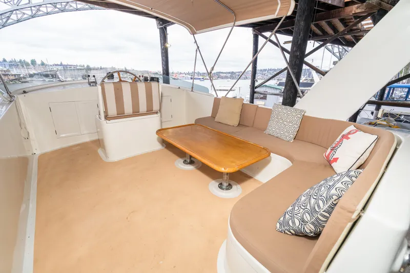 Slide: The Image of 1973 American Marine Alaskan 53 yacht interior with cozy seating and wooden table. - 62