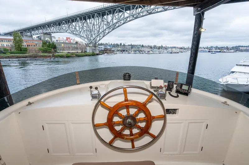 Slide: The Image of Helm of 1973 American Marine Alaskan 53 yacht with bridge and marina view. - 64