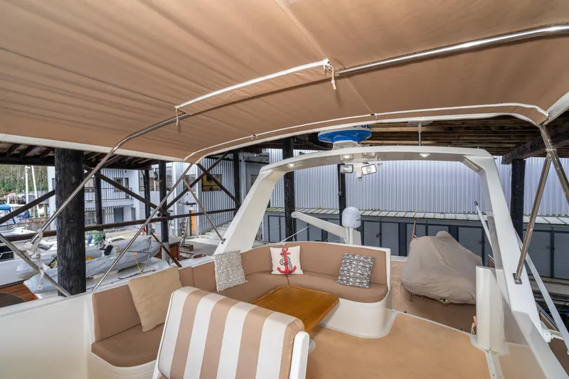 Slide: The Image of 1973 American Marine Alaskan 53 yacht interior with cushioned seating and canopy. - 66