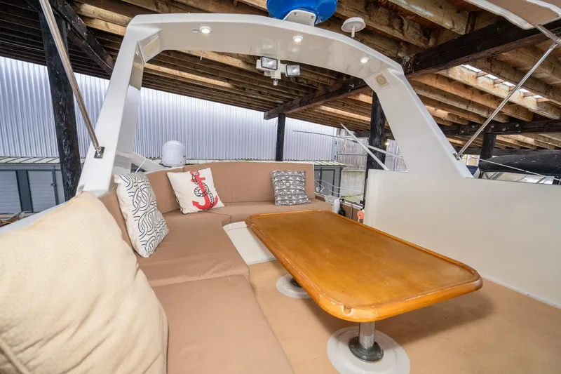 Slide: The Image of 1973 American Marine Alaskan 53 yacht interior with cushioned seating and wooden table. - 67