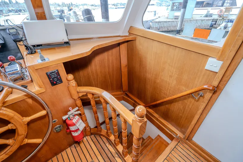 Slide: The Image of Interior of 1973 American Marine Alaskan 53 yacht with wooden staircase and steering wheel. - 7