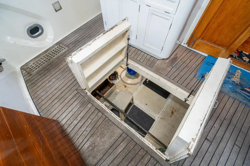 Slide: The Image of Open hatch on 1973 American Marine Alaskan 53 boat, revealing storage compartment. - 71