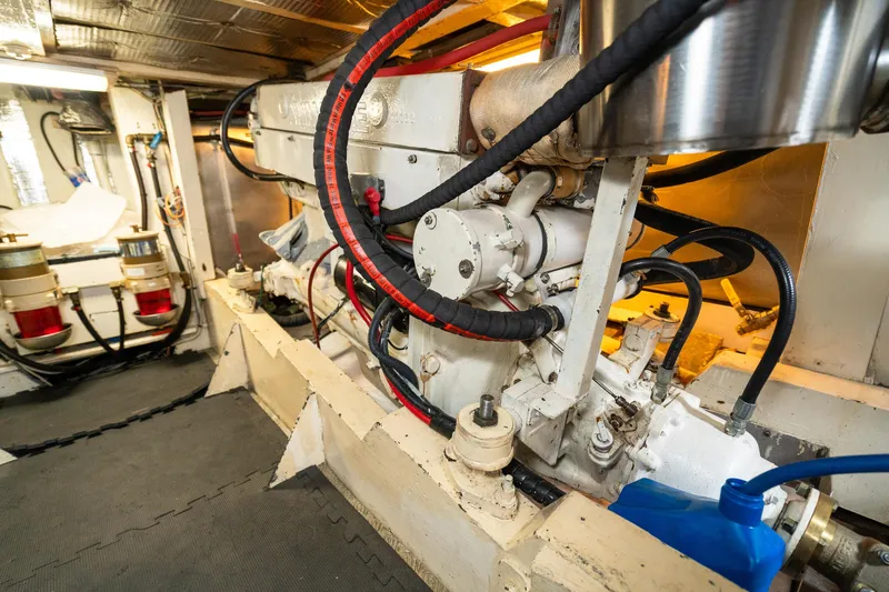 Slide: The Image of Engine room of a 1973 American Marine Alaskan 53 yacht, showcasing mechanical components. - 77