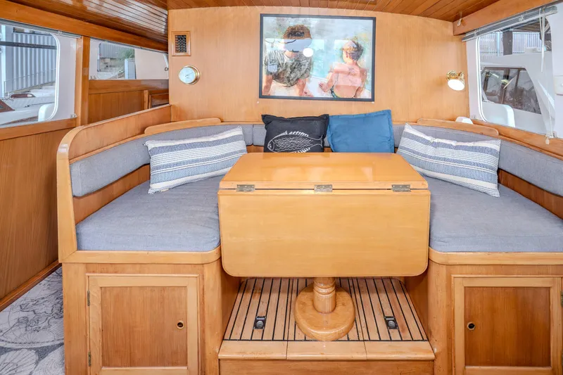 Slide: The Image of Interior of 1973 American Marine Alaskan 53 yacht with cozy seating and wooden table. - 8