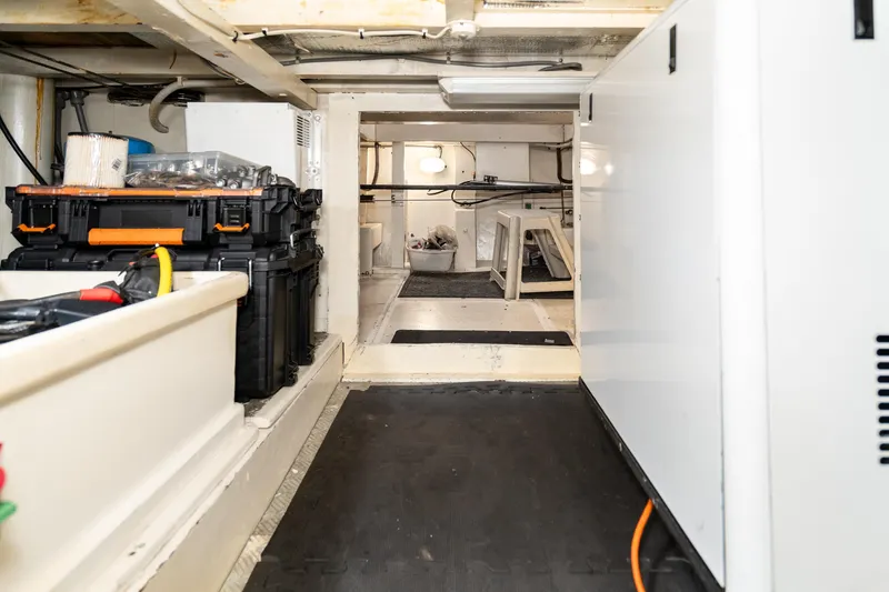 Slide: The Image of Engine room of 1973 American Marine Alaskan 53 yacht, featuring storage and equipment. - 80