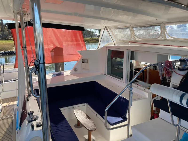 Slide: The Image of Interior view of a 2007 Lagoon 420 yacht with blue seating cushions. - 16