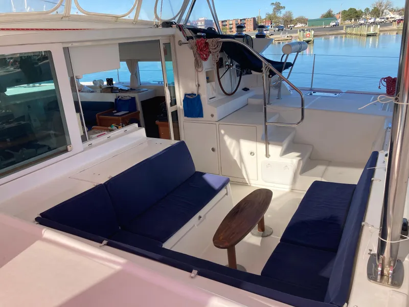 Slide: The Image of Interior of a 2007 Lagoon 420 yacht with blue seating cushions. - 17