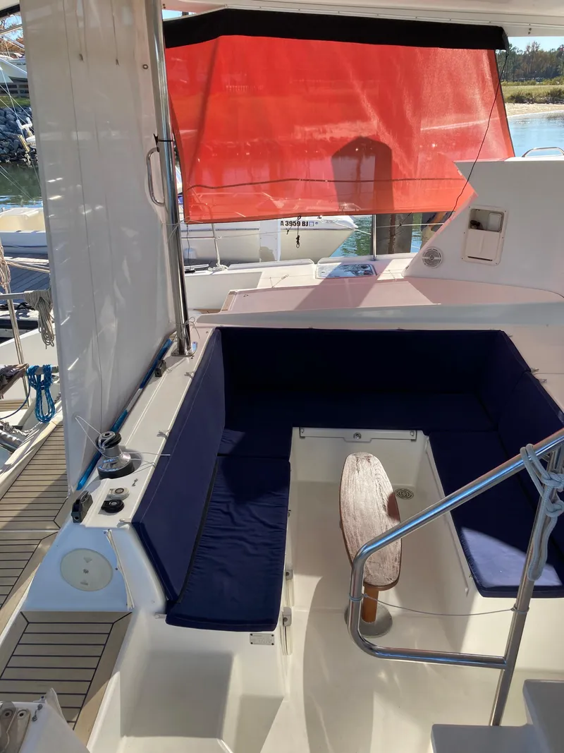 Slide: The Image of Interior of a 2007 Lagoon 420 yacht with blue seating cushions. - 18