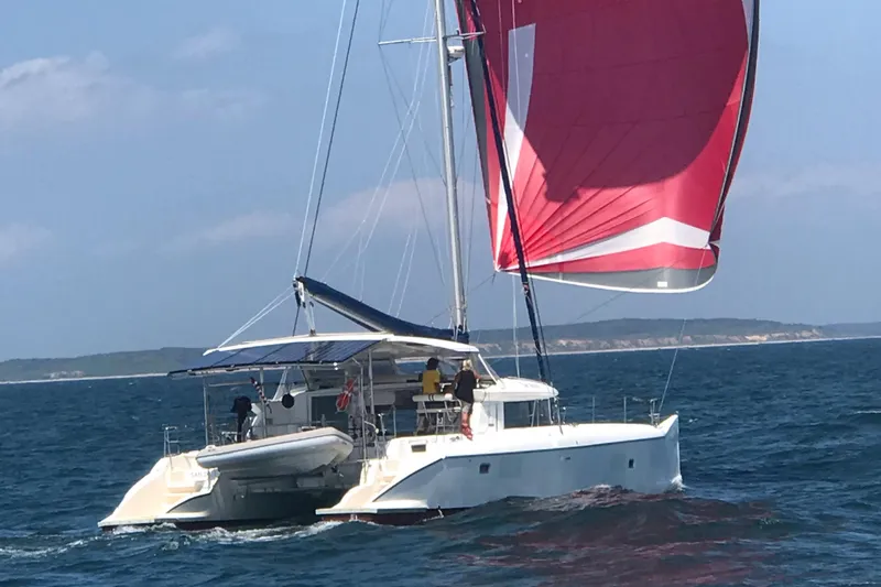 Slide: The Image of 2007 Lagoon 420 catamaran with red sail on the ocean. - 2