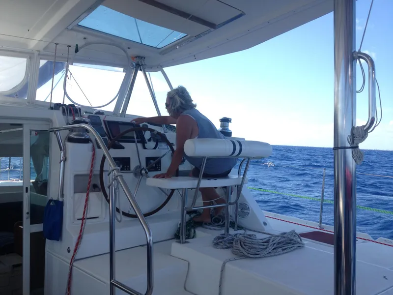 Slide: The Image of Person navigating Lagoon 420 catamaran on open sea. - 5