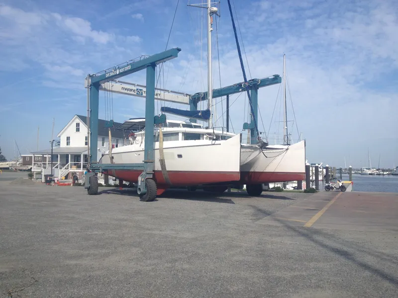 Slide: The Image of 2007 Lagoon 420 catamaran on a boat lift at the harbor. - 6