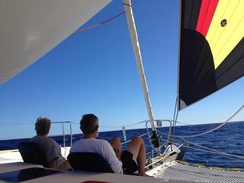 Slide: The Image of Two people relaxing on a 2007 Lagoon 420 yacht at sea. - 9