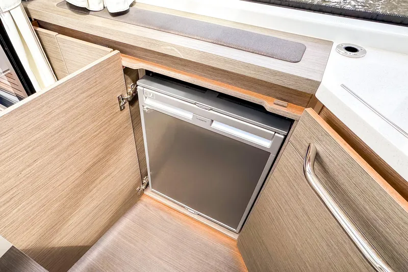 Slide: The Image of Compact refrigerator in 2025 Wellcraft 38 Explorer yacht's modern wooden cabinetry. - 24