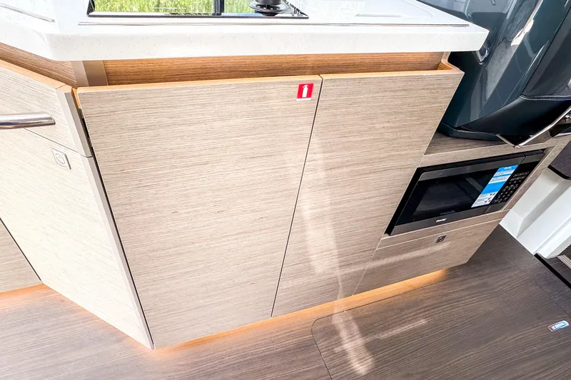 Slide: The Image of Modern kitchen area in 2025 Wellcraft 38 Explorer boat with sleek cabinetry and built-in microwave. - 28