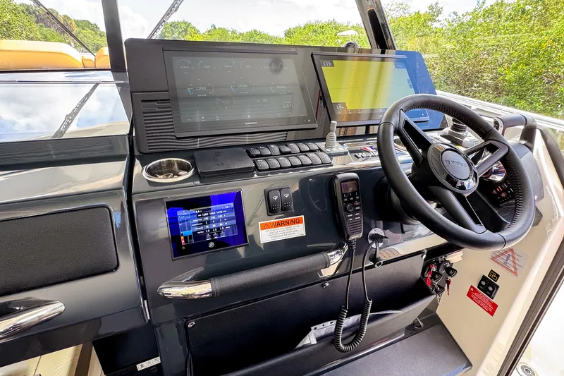 Slide: The Image of Helm of 2025 Wellcraft 38 Explorer with advanced navigation displays and controls. - 31