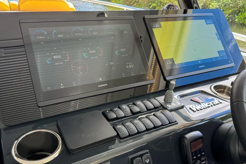 Slide: The Image of Dashboard of 2025 Wellcraft 38 Explorer with dual Garmin displays and control panel. - 32