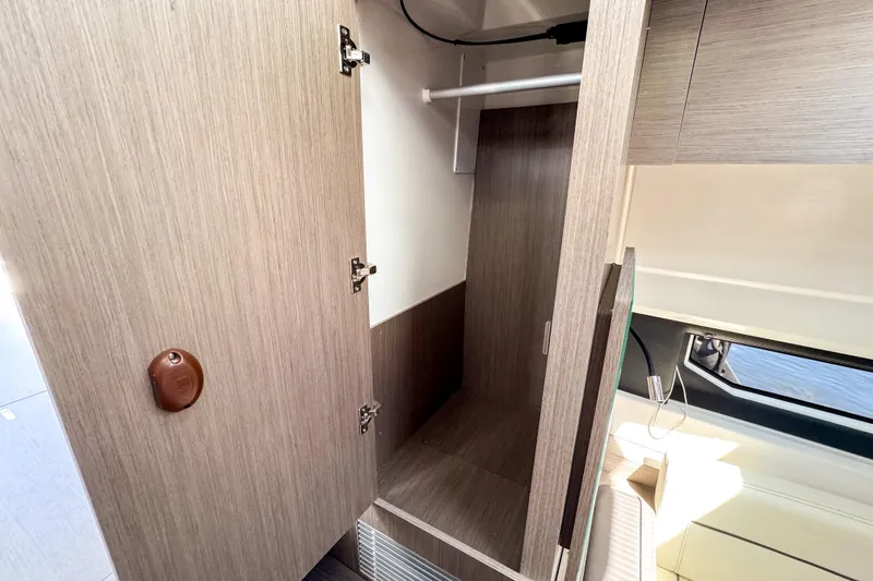 Slide: The Image of 2025 Wellcraft 38 Explorer interior closet with wooden finish and modern design. - 34