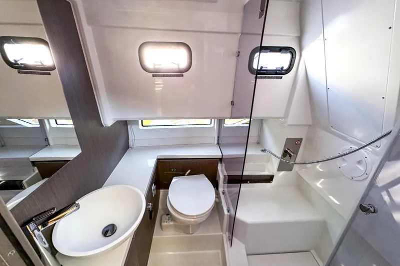 Slide: The Image of 2025 Wellcraft 38 Explorer bathroom with modern fixtures, sink, toilet, and shower area. - 38