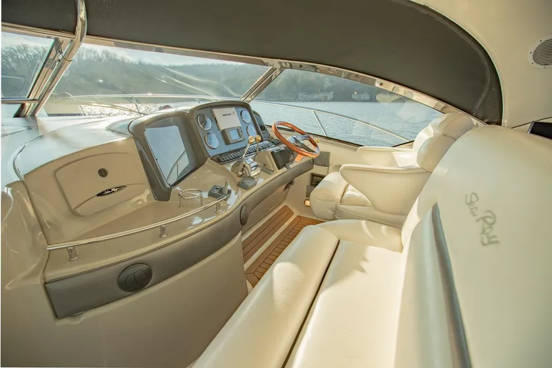 Slide: The Image of Luxurious 2005 Sea Ray 420 Sundancer yacht interior with modern dashboard and plush seating. - 10