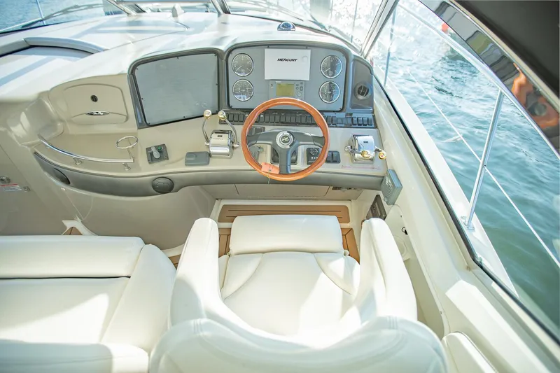 Slide: The Image of Interior helm of 2005 Sea Ray 420 Sundancer yacht with leather seating and wood-accented steering wheel. - 11