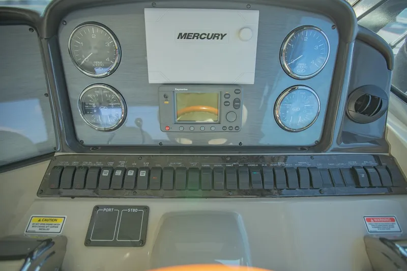 Slide: The Image of Control panel of 2005 Sea Ray 420 Sundancer boat with Mercury gauges and switches. - 12