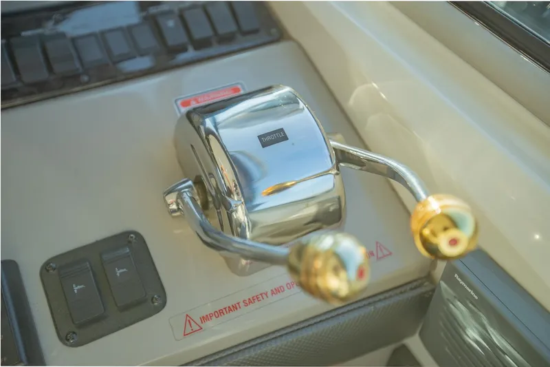 Slide: The Image of Close-up of 2005 Sea Ray 420 Sundancer throttle controls on the dashboard. - 13