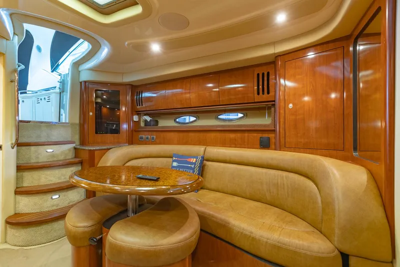 Slide: The Image of Luxurious 2005 Sea Ray 420 Sundancer yacht interior with elegant wood finishes and plush seating. - 15