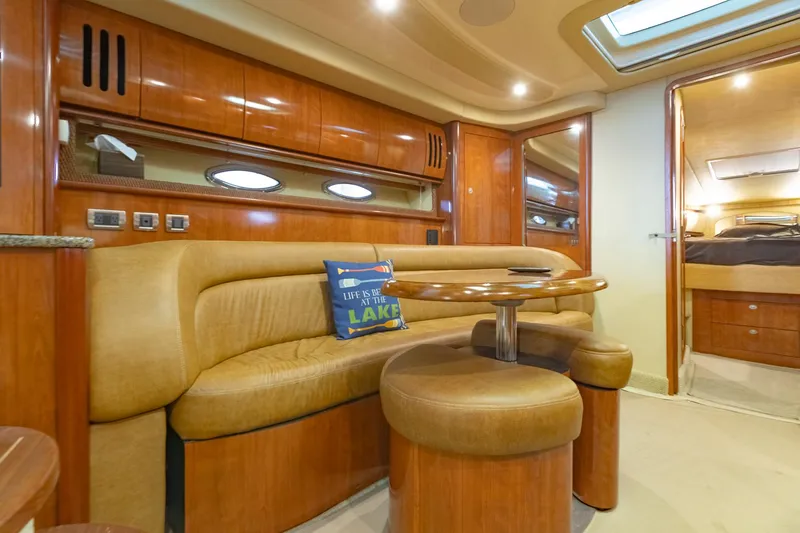 Slide: The Image of Luxurious 2005 Sea Ray 420 Sundancer yacht interior with plush seating and elegant wood finishes. - 16