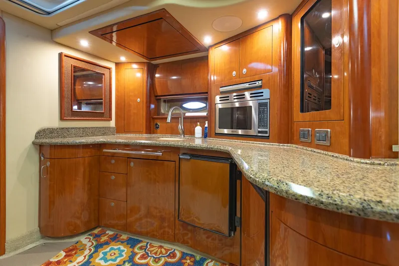 Slide: The Image of Luxurious kitchen interior of 2005 Sea Ray 420 Sundancer yacht with wood cabinetry. - 17