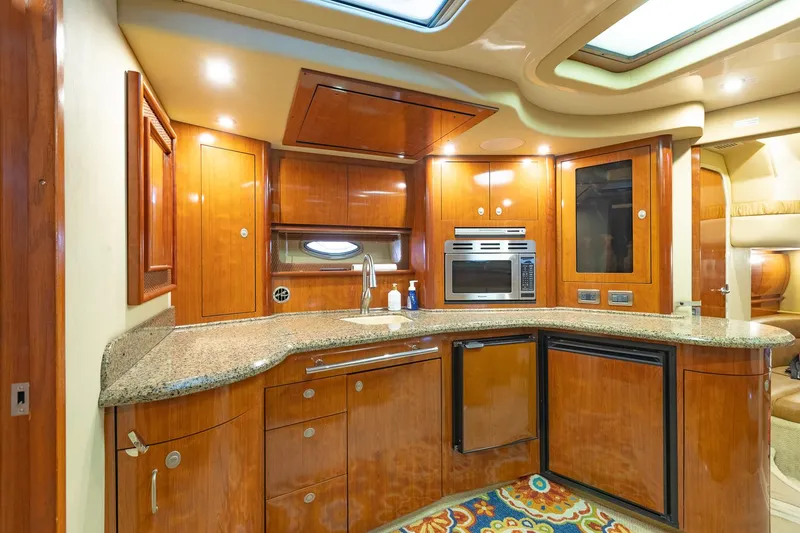 Slide: The Image of Luxurious 2005 Sea Ray 420 Sundancer yacht kitchen with wood cabinetry and modern appliances. - 18