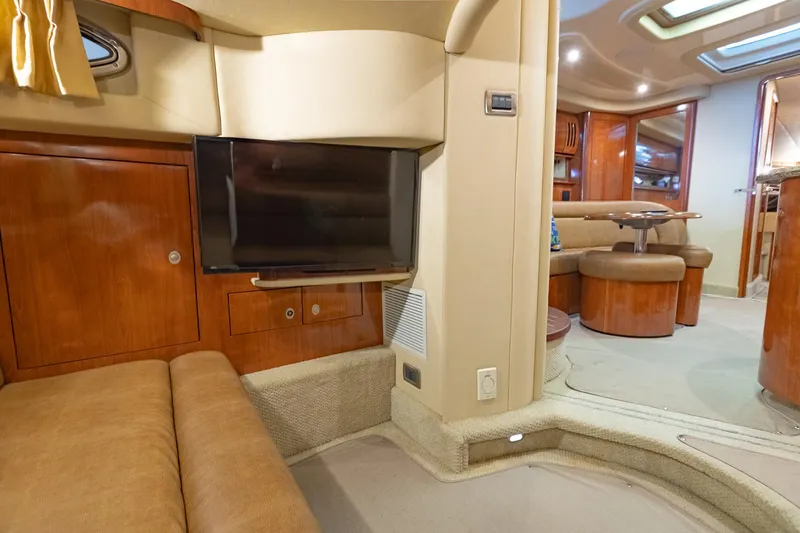 Slide: The Image of Luxurious interior of 2005 Sea Ray 420 Sundancer yacht with TV and seating area. - 24