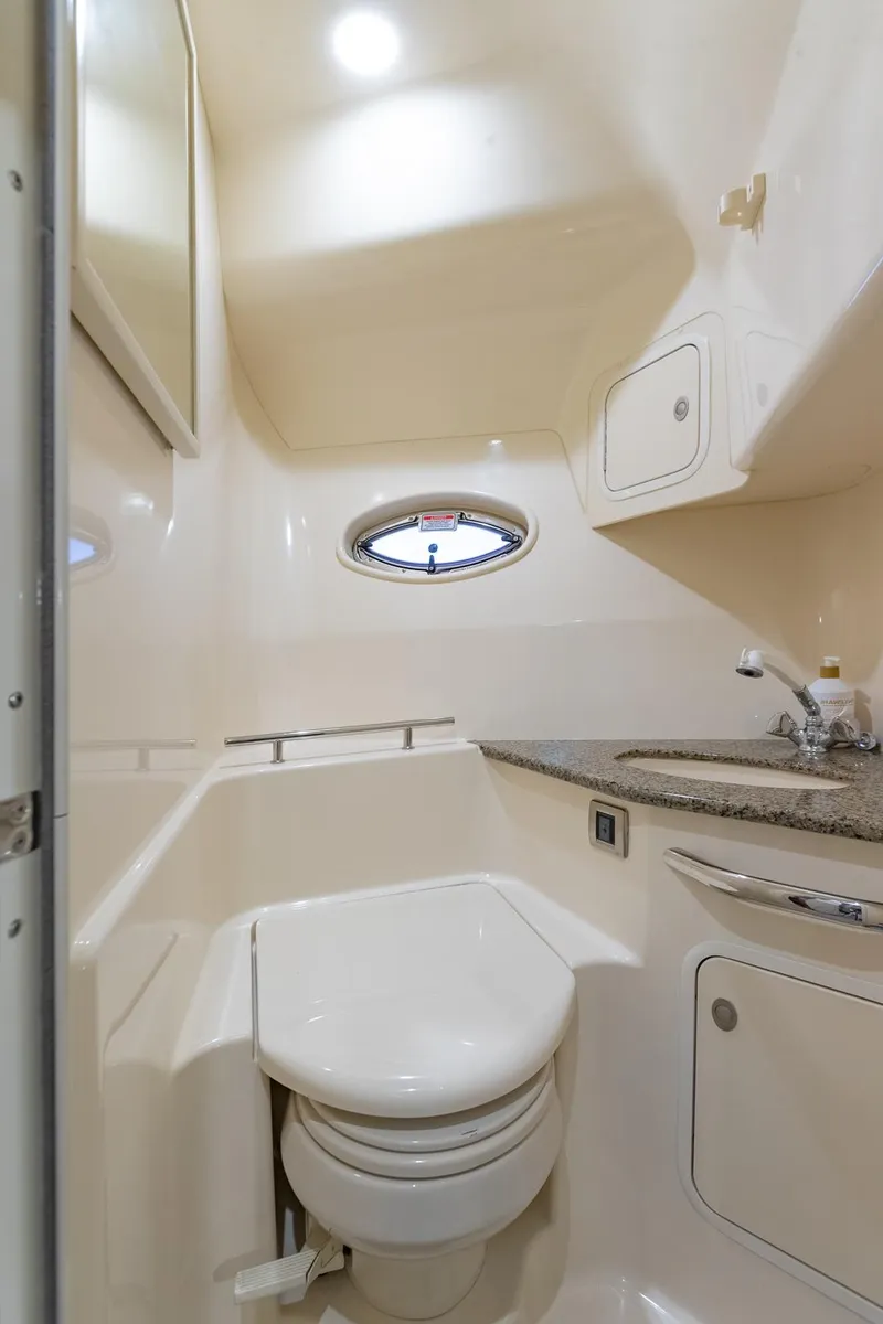 Slide: The Image of 2005 Sea Ray 420 Sundancer yacht bathroom with modern fixtures and compact design. - 25