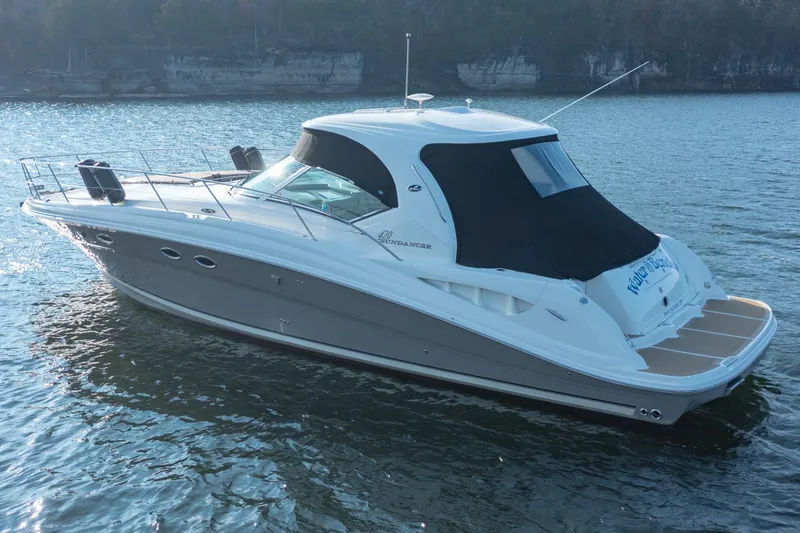 Slide: The Image of 2005 Sea Ray 420 Sundancer yacht on calm water, side view. - 3