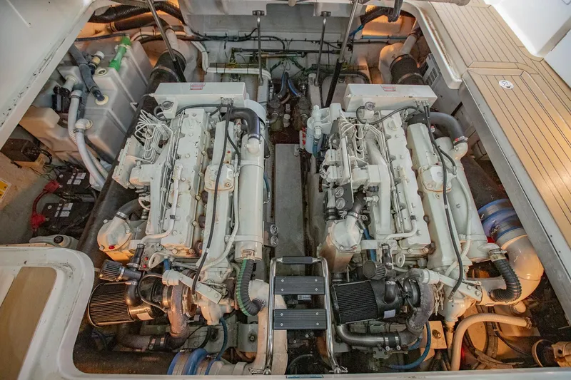 Slide: The Image of Engine room of 2005 Sea Ray 420 Sundancer with twin engines and mechanical components. - 33