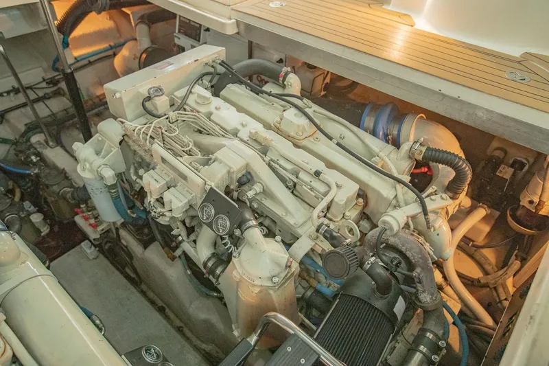 Slide: The Image of Engine compartment of 2005 Sea Ray 420 Sundancer boat, showcasing detailed mechanical components. - 34