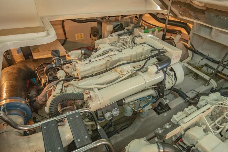 Slide: The Image of Engine room of 2005 Sea Ray 420 Sundancer yacht, showcasing detailed mechanical components. - 35