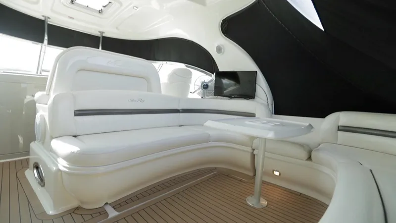 Slide: The Image of Luxurious interior of 2005 Sea Ray 420 Sundancer yacht with white seating and wood flooring. - 9