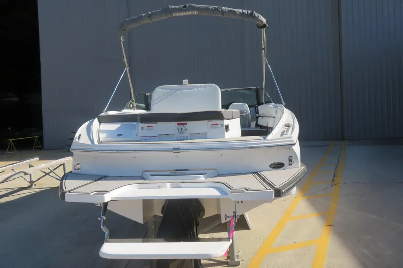 Slide: The Image of 2023 Cobalt CS22 boat, rear view, parked in a marina. - 3